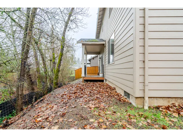a backyard of a house with a yard fire pit and wooden fence