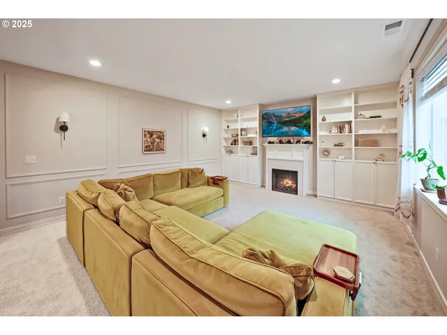 a living room with furniture fireplace and flat screen tv