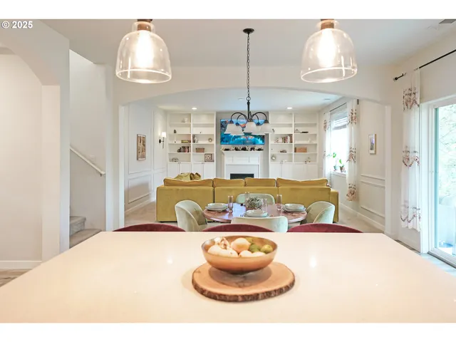 a living room with kitchen island furniture and a chandelier