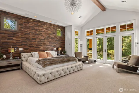 a spacious bedroom with a bed couch and a large window