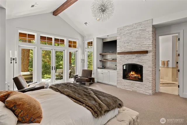 a spacious bedroom with a bed and a fireplace