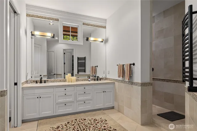 a bathroom with a double vanity sink and mirror