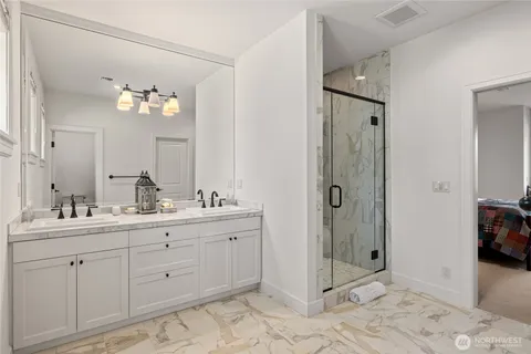 a spacious bathroom with a shower sink and mirror