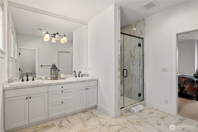 a spacious bathroom with a shower sink and mirror