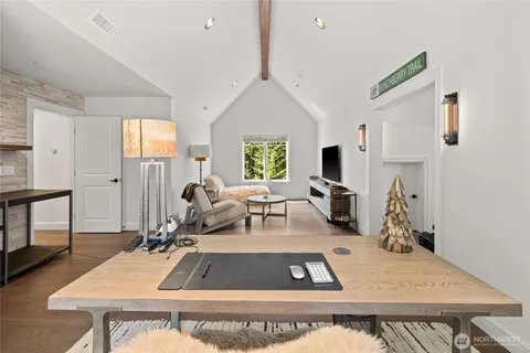 a room with furniture a rug and white walls