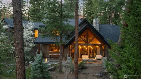 a backyard of a house with wooden fence and trees