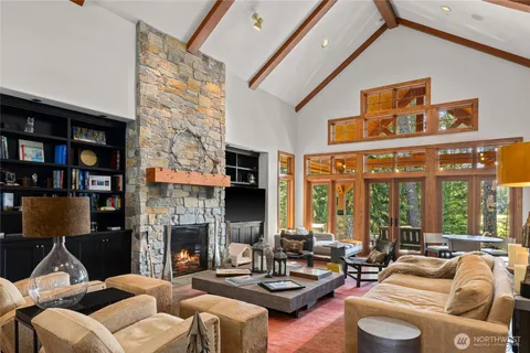 a living room with furniture fireplace and a large window
