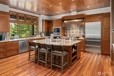 a large kitchen with a table and chairs