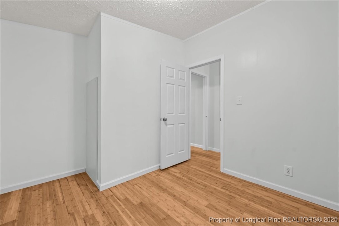 11891 Aberdeen Road Aberdeen, NC 28315 - Photo 22 of 35 a view of an empty room with wooden floor