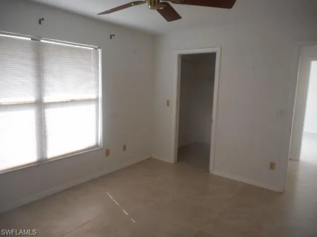a kitchen with granite countertop stainless steel appliances a sink and a refrigerator