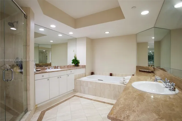 a bathroom with a tub sink and mirror
