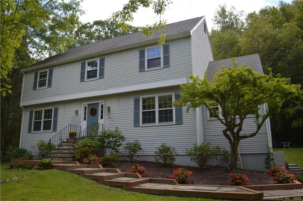 89 Scodon Drive Ridgefield, CT 06877 - Photo 1 of 1 a front view of a house with garden
