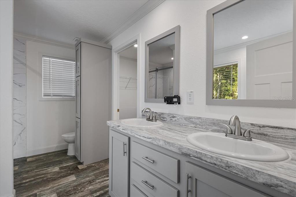 4654 Northwest 45th Avenue Bell, FL 32619 - Photo 15 of 52 a bathroom with a sink double vanity and a mirror