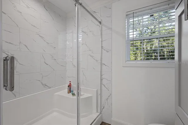 a bathroom with a tub a sink and a window