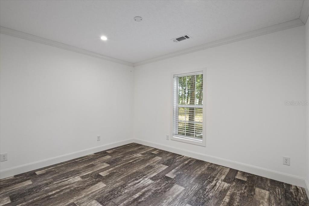 4654 Northwest 45th Avenue Bell, FL 32619 - Photo 24 of 52 a view of empty room with wooden floor
