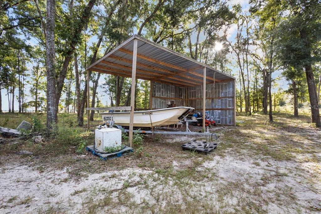 4654 Northwest 45th Avenue Bell, FL 32619 - Photo 37 of 52 a backyard of a house with barbeque oven table and chairs
