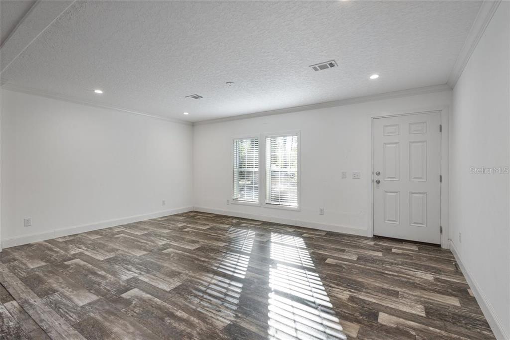4654 Northwest 45th Avenue Bell, FL 32619 - Photo 4 of 52 a view of empty room with wooden floor and fan