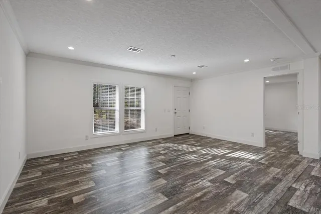 a view of a kitchen with a sink and wooden floor