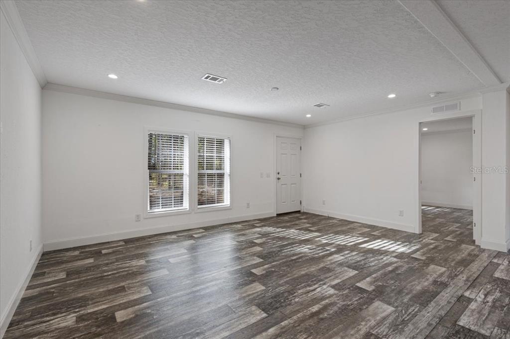 4654 Northwest 45th Avenue Bell, FL 32619 - Photo 5 of 52 a view of an empty room with wooden floor and a window