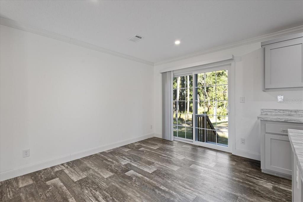4654 Northwest 45th Avenue Bell, FL 32619 - Photo 10 of 52 a view of empty room with wooden floor and fan