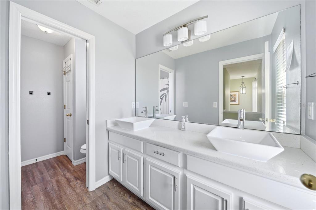 2614 Grapevine Crest Ocoee, FL 34761 - Photo 13 of 24 a spacious en suite bathroom with a granite countertop sink mirror and a