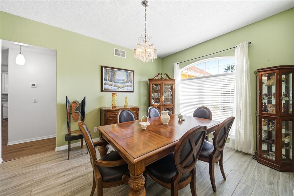 2614 Grapevine Crest Ocoee, FL 34761 - Photo 16 of 24 a view of a dining room with furniture window and wooden floor