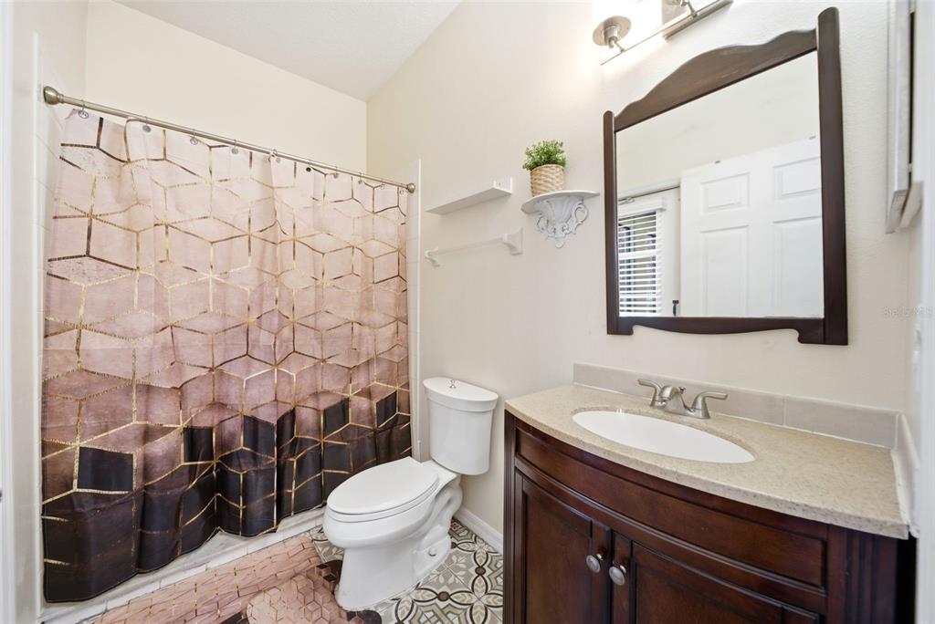 2614 Grapevine Crest Ocoee, FL 34761 - Photo 17 of 24 a bathroom with a granite countertop sink toilet and shower