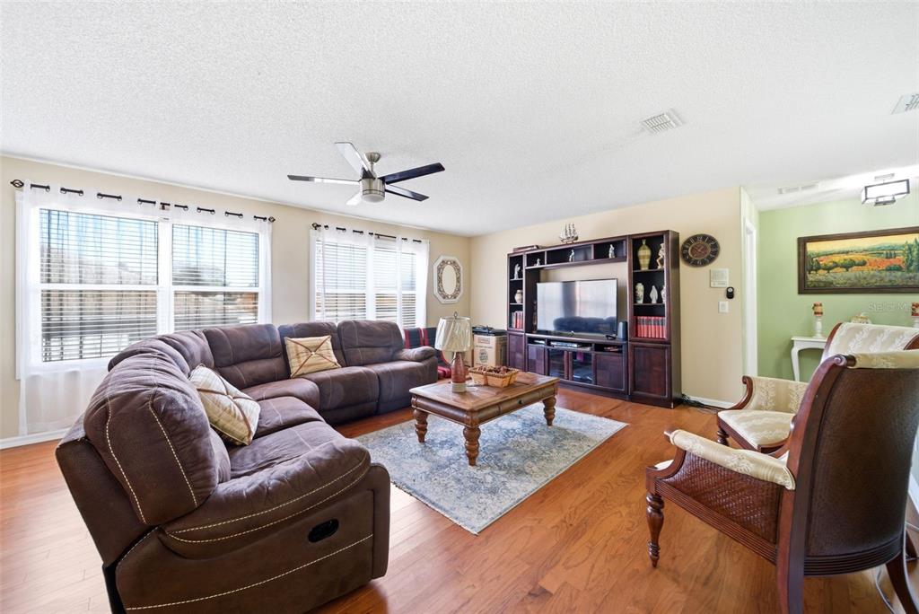2614 Grapevine Crest Ocoee, FL 34761 - Photo 18 of 24 a living room with furniture and a flat screen tv