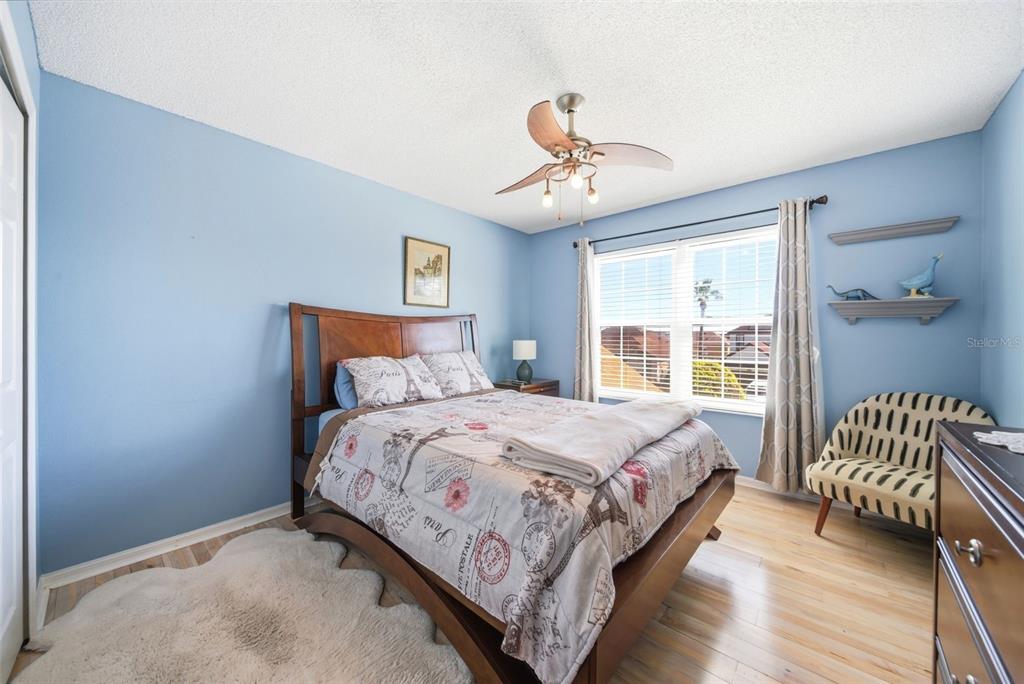 2614 Grapevine Crest Ocoee, FL 34761 - Photo 19 of 24 a bedroom with a bed and a chandelier