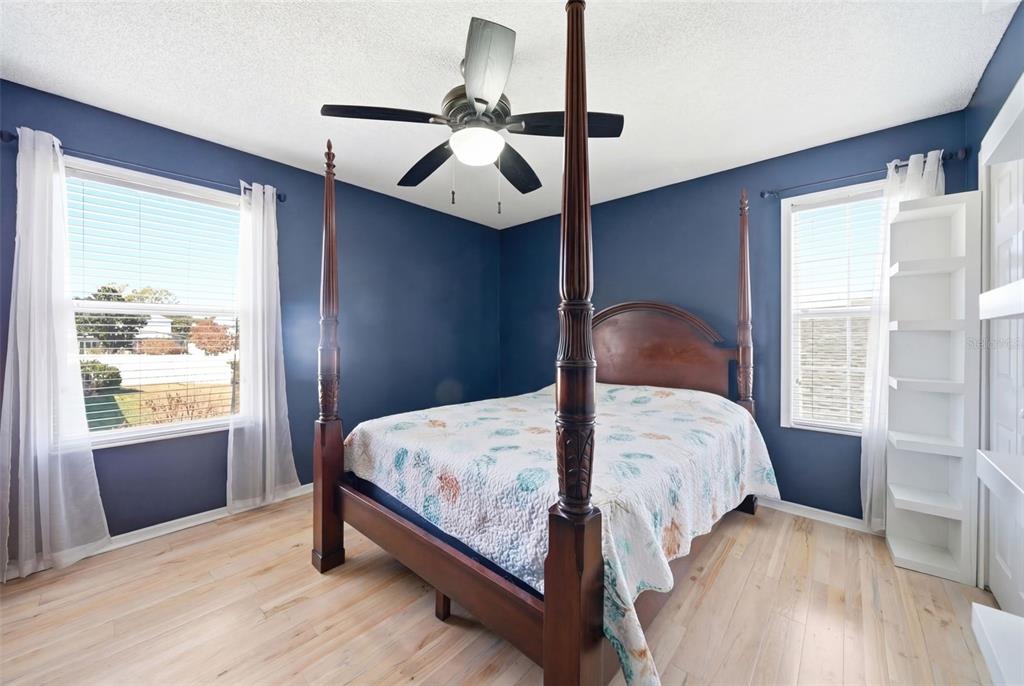 2614 Grapevine Crest Ocoee, FL 34761 - Photo 20 of 24 a bedroom with a bed lamp and window