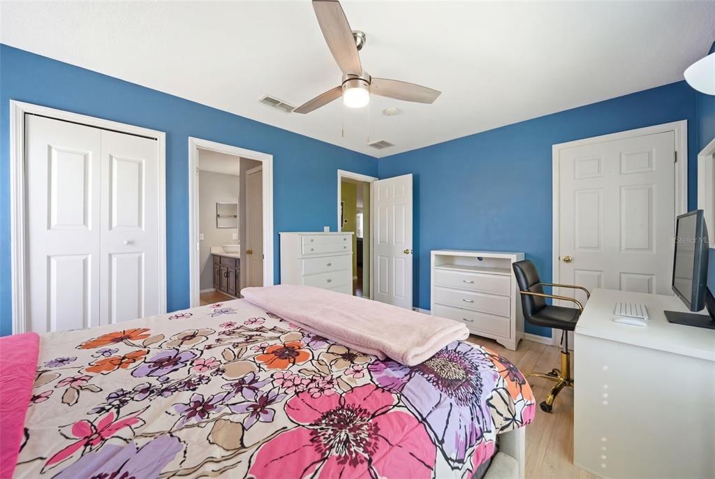 2614 Grapevine Crest Ocoee, FL 34761 - Photo 21 of 24 a bedroom with a bed and a flat screen tv