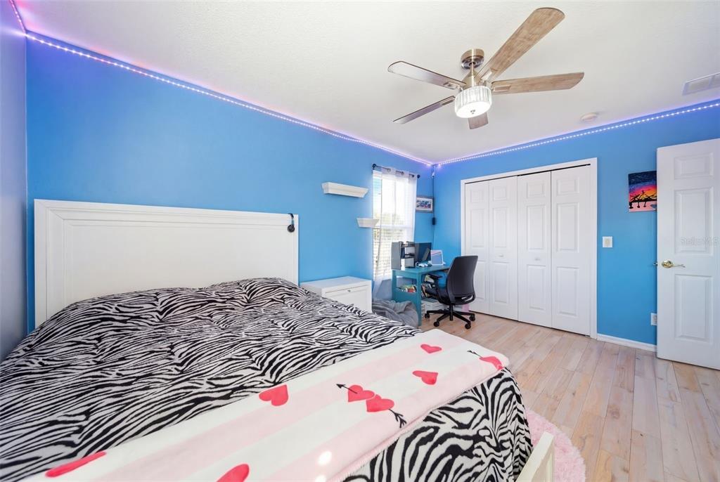 2614 Grapevine Crest Ocoee, FL 34761 - Photo 22 of 24 a bedroom with a bed and a chandelier
