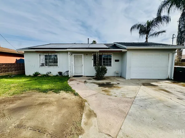 a front view of a house with a garden and plants