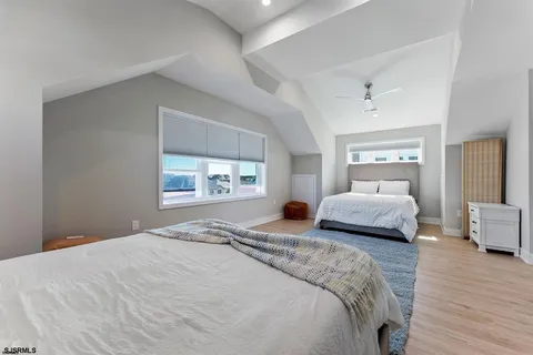 a bedroom with a large bed and wooden floor