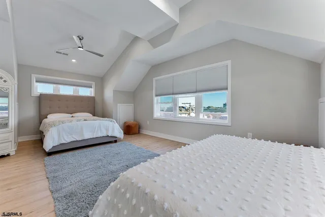 a bedroom with a large bed and a window