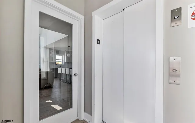 a bathroom with a glass shower door and a mirror