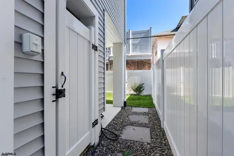 a view of a hallway with wooden floor and entryway