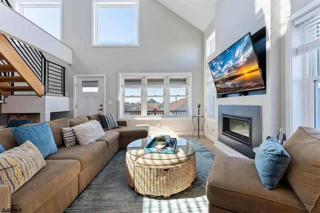 a living room with furniture a fireplace and a flat screen tv