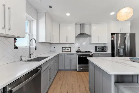 a kitchen with a sink stainless steel appliances and cabinets