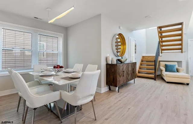 a view of a dining room with furniture window and wooden floor