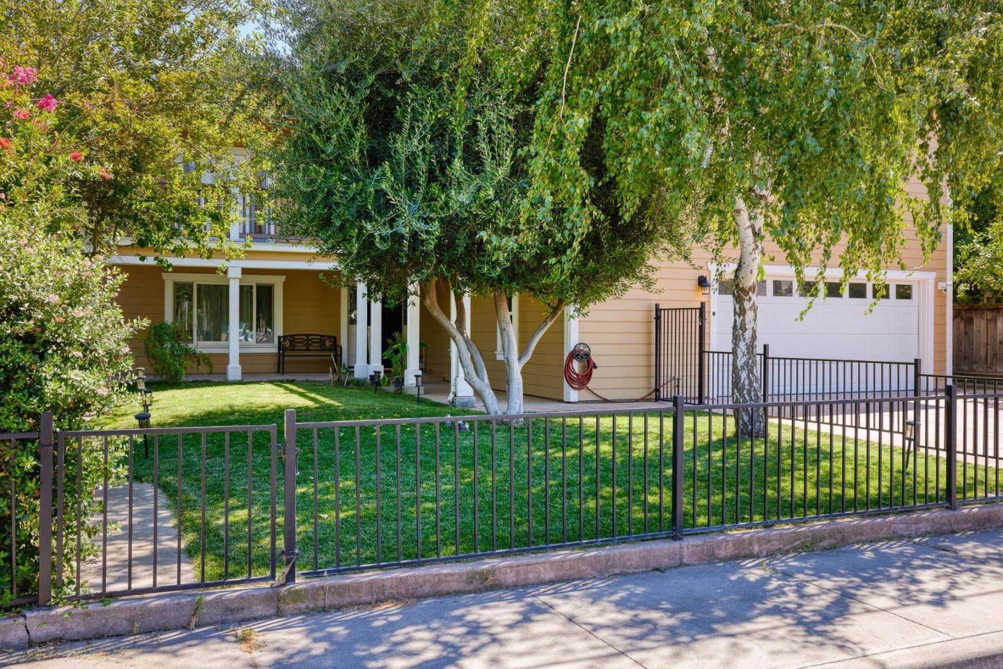 1504 Mable Avenue Modesto, CA 95355 - Photo 13 of 47 a front view of a house with a garden