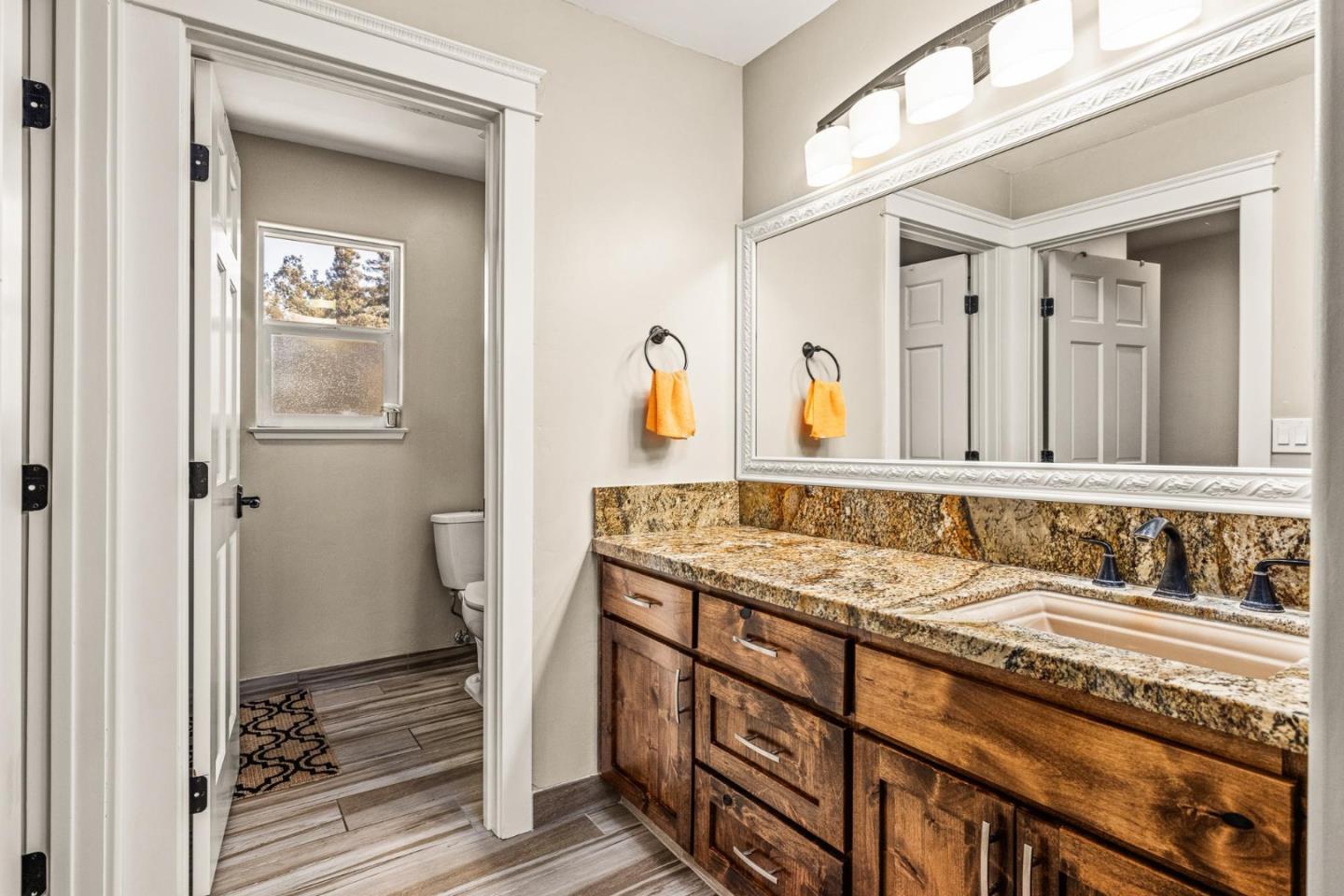 1504 Mable Avenue Modesto, CA 95355 - Photo 24 of 47 a bathroom with a granite countertop sink and a mirror