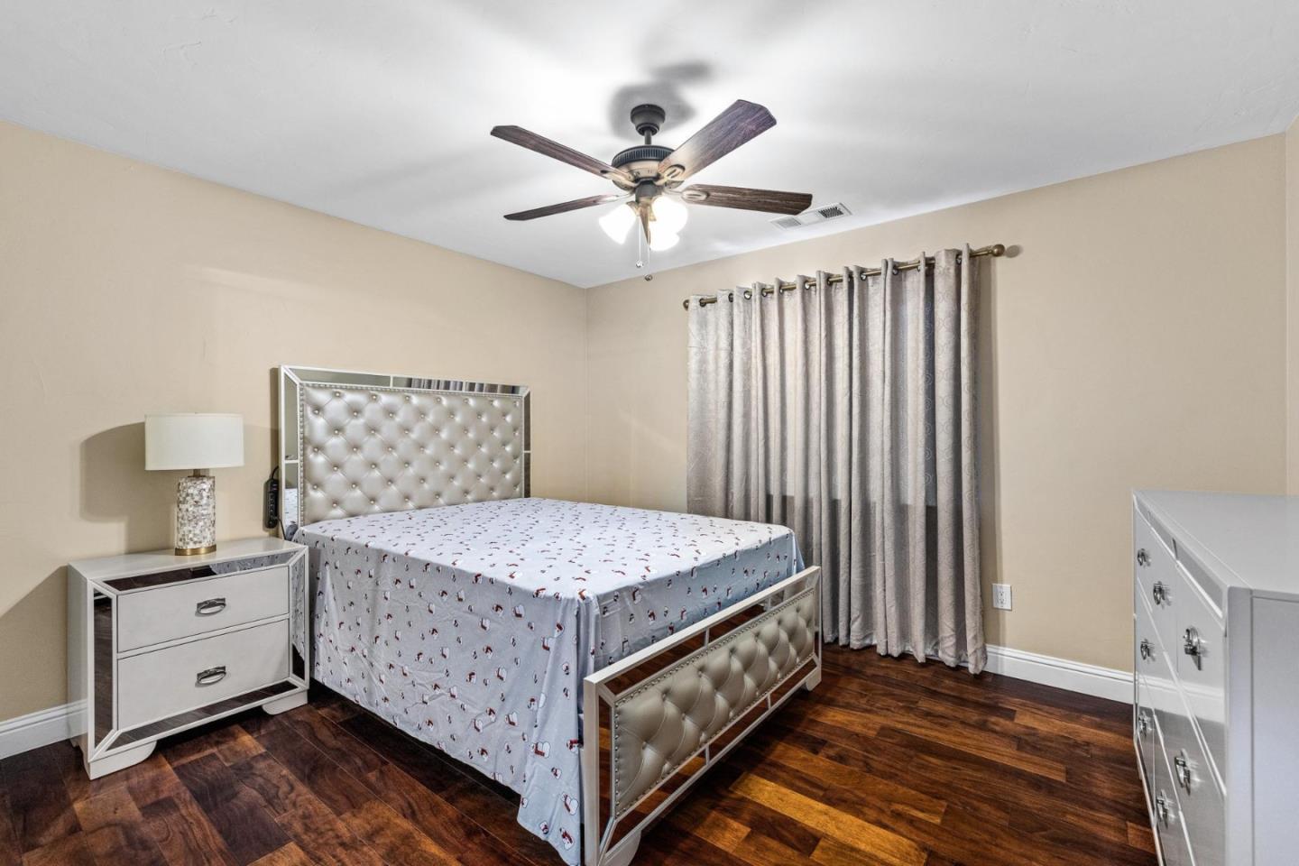 1504 Mable Avenue Modesto, CA 95355 - Photo 33 of 47 a bedroom with a bed and a chandelier