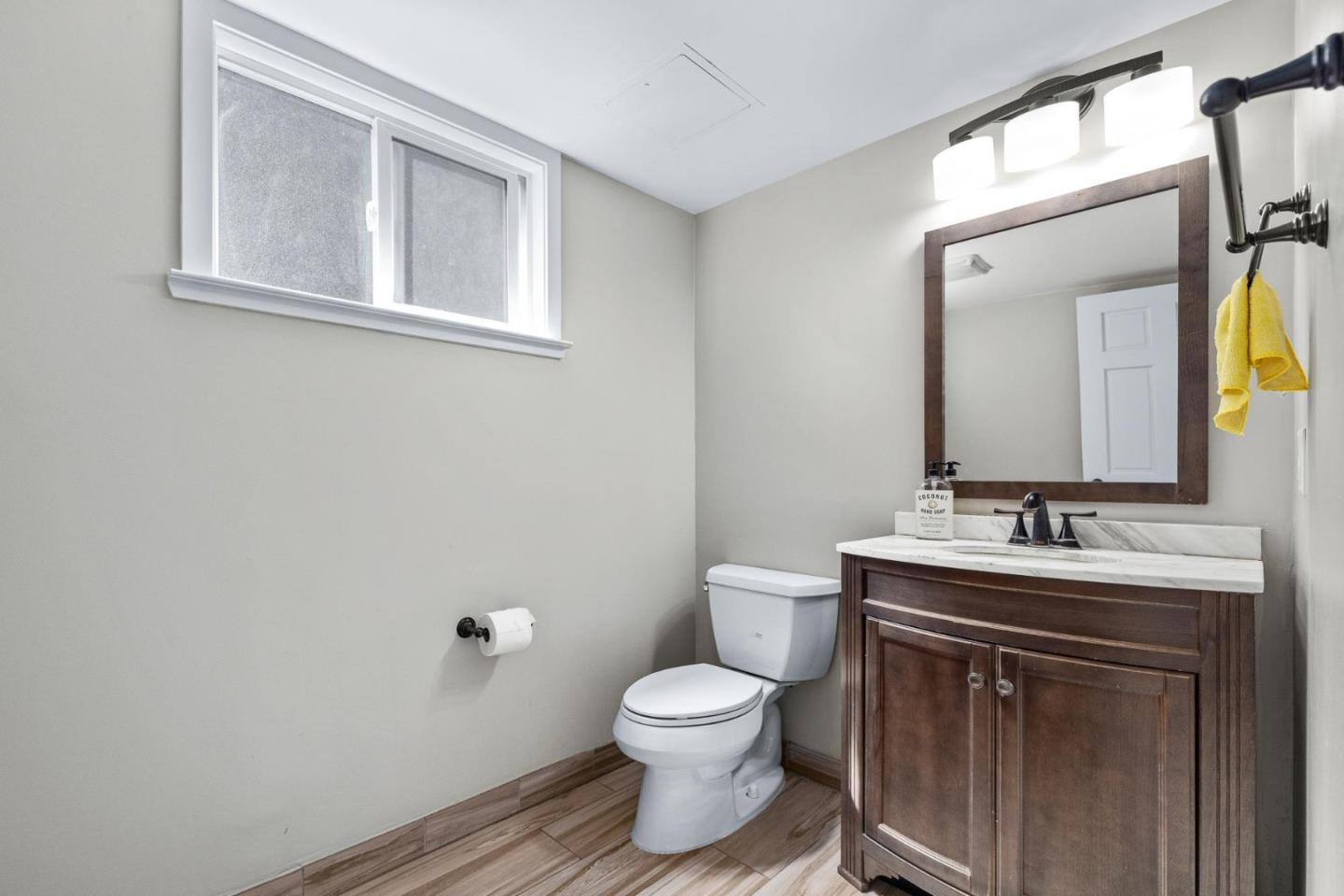 1504 Mable Avenue Modesto, CA 95355 - Photo 34 of 47 a bathroom with a toilet a sink and mirror