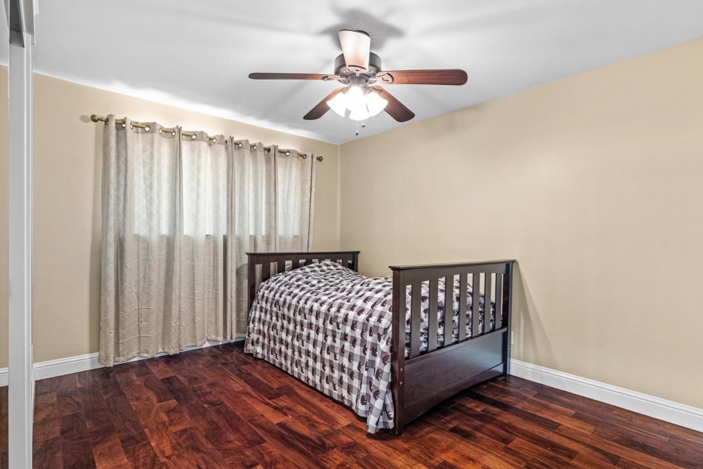 1504 Mable Avenue Modesto, CA 95355 - Photo 35 of 47 a bedroom with a bed and a chandelier