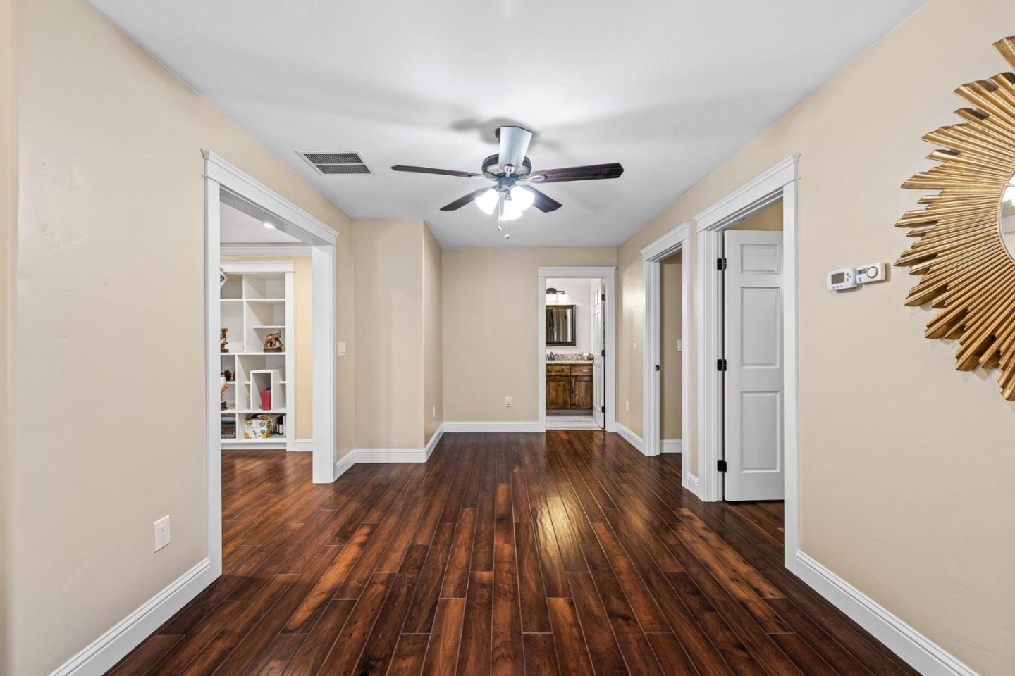 1504 Mable Avenue Modesto, CA 95355 - Photo 36 of 47 a view of a big room with wooden floor a ceiling fan and windows