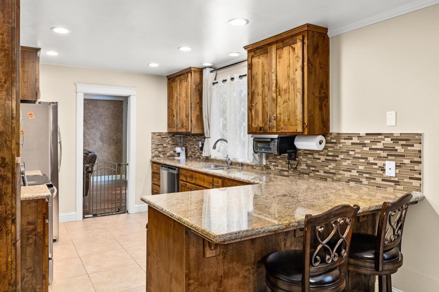1504 Mable Avenue Modesto, CA 95355 - Photo 8 of 47 a kitchen with kitchen island granite countertop a sink and counter space