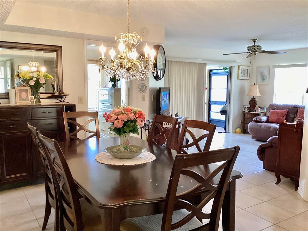 4529 Whitton Way, Unit 214 New Port Richey, FL 34653 - Photo 13 of 45 a view of a dining room with furniture and chandelier