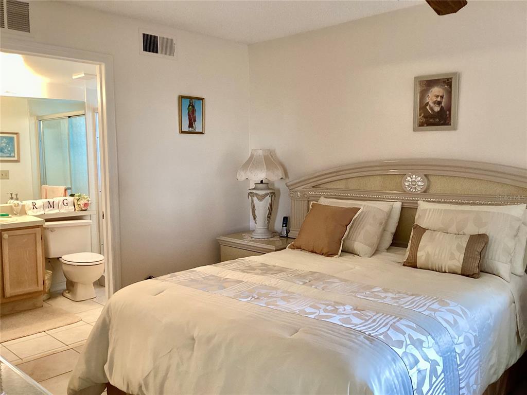 4529 Whitton Way, Unit 214 New Port Richey, FL 34653 - Photo 16 of 45 a bedroom with a bed and a painting on the wall