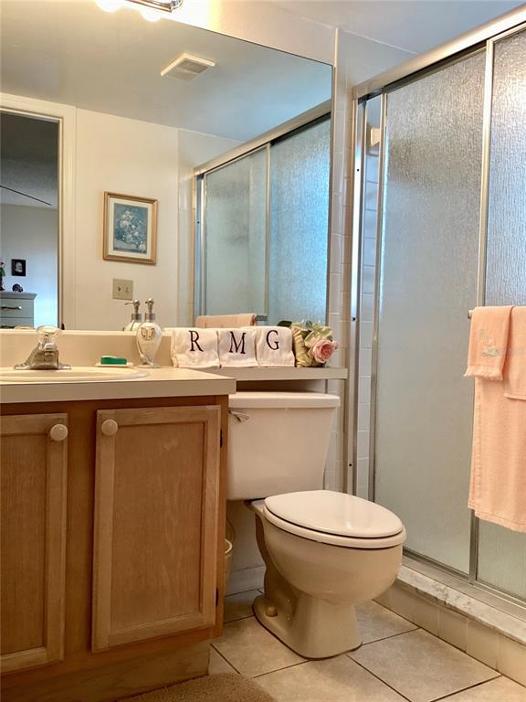 4529 Whitton Way, Unit 214 New Port Richey, FL 34653 - Photo 18 of 45 a bathroom with a toilet sink vanity and mirror